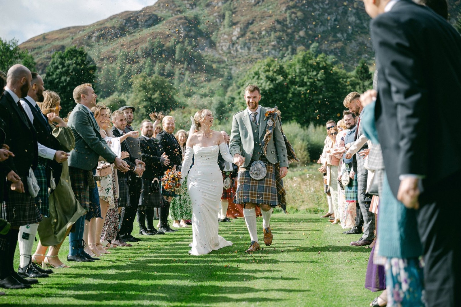 Guests lining the aisle in a Highland glen