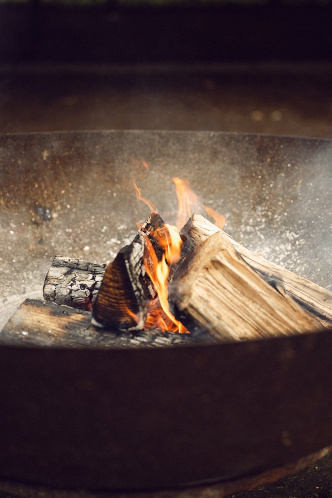 A fire pit glowing at a wedding reception