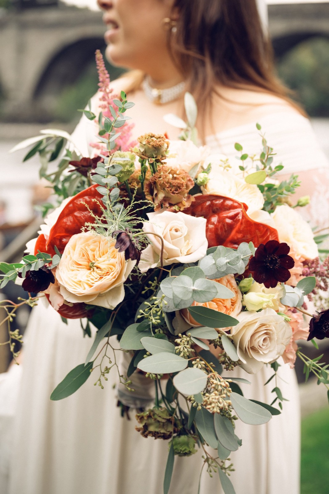 A bride holding an autumn bouquet